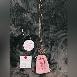 This piece is a Vintage plaques dangles parred with a 1980s necklace.